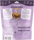 A purple packaging bag of Island of Pets Air-dried Dental Cubes featuring a cartoon dog in a boat. The back of the bag highlights the products benefits, including dental care and ingredients, with nutritional information and a playful.